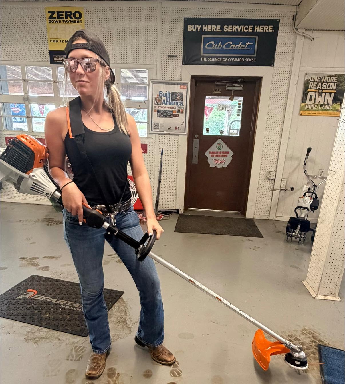 Customer with a new Stihl trimmer inside the store