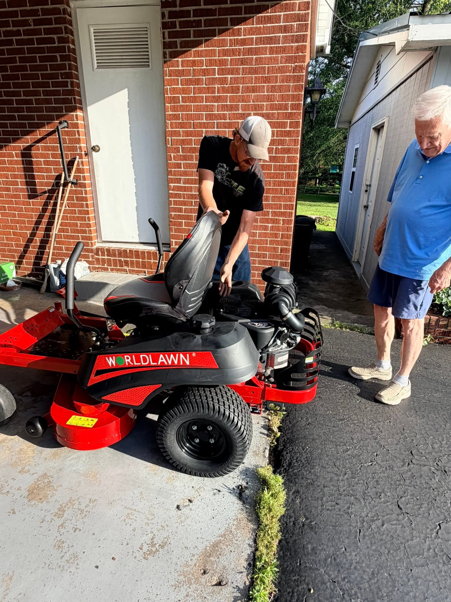 Cole Power team delivering a Worldlawn zero-turn mower to a customer